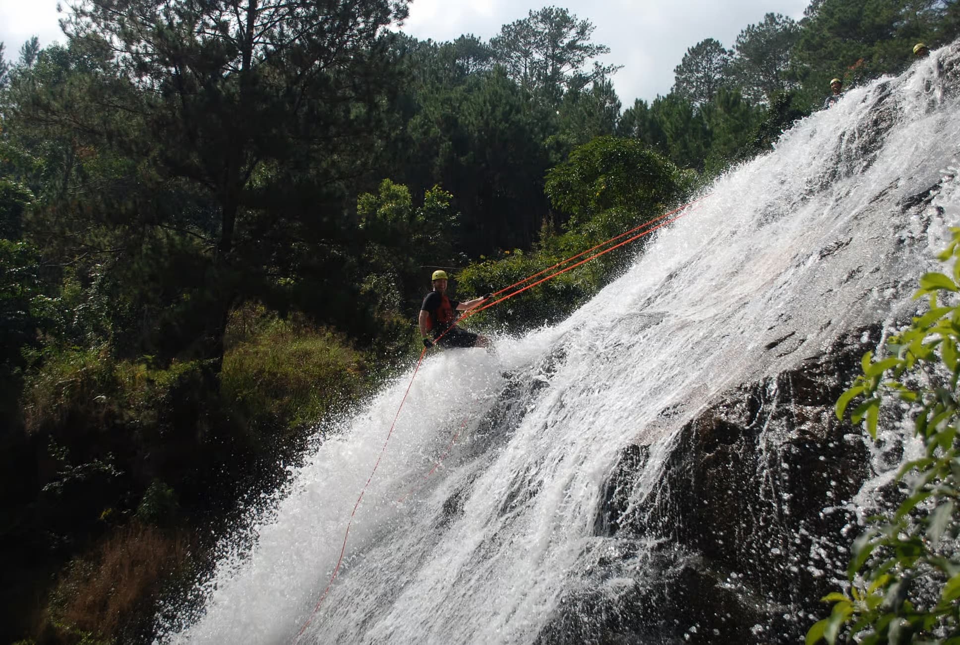 Abseiling down a waterfall on the Datanla canyoning tour