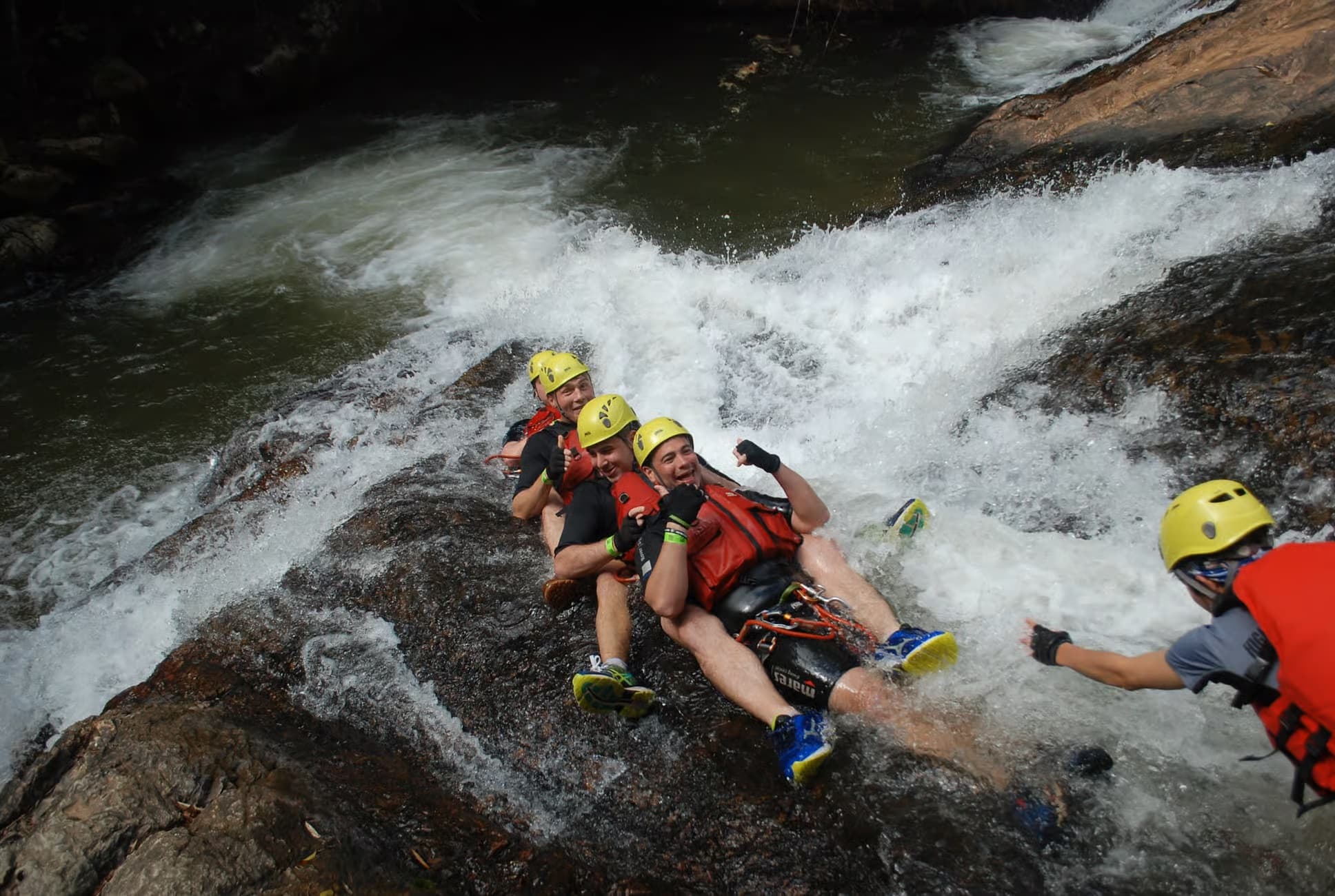 Travellers abseiling beside Datanla Waterfall in Da Lat