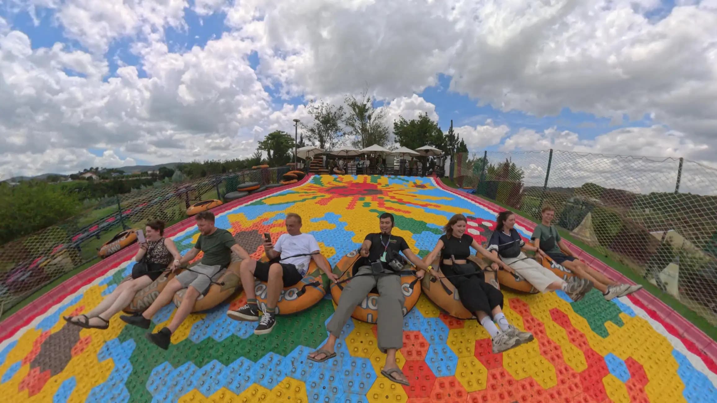 Group sliding down the rainbow slide at Mongo Land